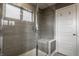 Modern bathroom featuring a glass enclosed shower, and sleek gray tiling at 13306 Saxony W Blvd, Fishers, IN 46037