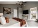 Cozy bedroom with a king bed, ceiling fan, and a view into the ensuite bathroom at 13306 Saxony W Blvd, Fishers, IN 46037