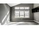 Bright bedroom with large windows overlooking a building with a lawn at 13306 Saxony W Blvd, Fishers, IN 46037
