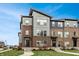 New construction of modern townhomes with brick and siding and manicured lawns at 13306 Saxony W Blvd, Fishers, IN 46037