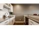 Kitchen counter featuring white cabinets, stainless steel appliances, and modern fixtures at 13306 Saxony W Blvd, Fishers, IN 46037