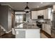 Well-lit kitchen featuring a large island, stainless steel appliances, and modern pendant lighting at 13306 Saxony W Blvd, Fishers, IN 46037