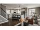 Open-concept kitchen featuring white cabinets, stainless steel appliances, and a breakfast bar at 13306 Saxony W Blvd, Fishers, IN 46037