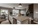 Open-concept kitchen and living area with an island, stainless steel appliances, and hardwood flooring at 13306 Saxony W Blvd, Fishers, IN 46037