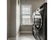 Laundry room with stainless steel washer and dryer and view from window at 13306 Saxony W Blvd, Fishers, IN 46037