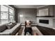 Cozy living room features a fireplace, large windows and modern furniture at 13306 Saxony W Blvd, Fishers, IN 46037