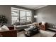Bright living room with modern sofa, accent chairs, and a large window at 13306 Saxony W Blvd, Fishers, IN 46037