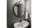 Pedestal sink in powder room with white towel and mirror at 13306 Saxony W Blvd, Fishers, IN 46037