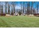 A green lawn with a tree line and modern art sculptures, and walking paths at 13306 Saxony W Blvd, Fishers, IN 46037