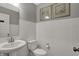 Cozy powder room featuring a pedestal sink, toilet, and white subway tile, accented by two framed art pieces at 15372 Hurst Rd, Fishers, IN 46040