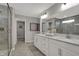 Modern bathroom featuring a double sink vanity, shower with glass enclosure, and tile flooring at 15372 Hurst Rd, Fishers, IN 46040