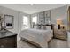 Comfortable bedroom with a large bed, side tables, stylish decor, and a view through bright windows at 15372 Hurst Rd, Fishers, IN 46040