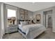 Bright bedroom with a large bed, decorative pillows, neutral tones, and natural light from a large window at 15372 Hurst Rd, Fishers, IN 46040