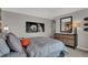 This bedroom offers neutral walls, stylish furniture, and football themed decor at 15372 Hurst Rd, Fishers, IN 46040