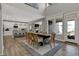 Open-concept dining room with soaring ceilings, modern light fixtures, and seamless flow into the adjacent kitchen at 15372 Hurst Rd, Fishers, IN 46040