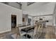 Formal dining room with decorative chandelier, hardwood floors, wine cellar and a view into the modern kitchen at 15372 Hurst Rd, Fishers, IN 46040