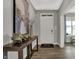 Welcoming entryway featuring wood-look floors, console table with modern decor, and a view to the outdoors at 15372 Hurst Rd, Fishers, IN 46040