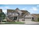 Charming two-story home with gray siding, three-car garage, manicured lawn, and a welcoming front porch at 15372 Hurst Rd, Fishers, IN 46040