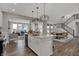 Modern kitchen with island, stainless appliances, and open view to the living room and dining area at 15372 Hurst Rd, Fishers, IN 46040