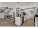 Modern kitchen with island, stainless appliances, and open view to the dining room and staircase at 15372 Hurst Rd, Fishers, IN 46040