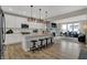 Modern kitchen with white cabinets, stainless steel appliances, granite countertops, and an island with seating at 15372 Hurst Rd, Fishers, IN 46040