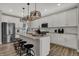 Modern kitchen with white cabinets, stainless steel appliances, granite countertops, and an island with seating at 15372 Hurst Rd, Fishers, IN 46040