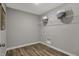 A simple yet functional laundry room with wood-look flooring and convenient shelving at 15372 Hurst Rd, Fishers, IN 46040