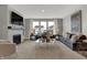 Spacious living room featuring a fireplace, large windows, neutral color palette and modern decor at 15372 Hurst Rd, Fishers, IN 46040