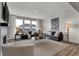 Bright and airy living room with a fireplace, large windows, and stylish furnishings at 15372 Hurst Rd, Fishers, IN 46040