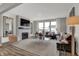 Spacious living room with a fireplace, large windows, comfortable seating and modern decor at 15372 Hurst Rd, Fishers, IN 46040
