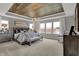 Spacious main bedroom with a tray ceiling, large windows, and comfortable furnishings at 15372 Hurst Rd, Fishers, IN 46040