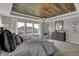 Bright main bedroom with a beautiful wood plank ceiling and large windows that offer great natural light at 15372 Hurst Rd, Fishers, IN 46040