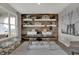 Stylish home office with a wood accent wall, modern desk, comfortable seating, and ample natural light at 15372 Hurst Rd, Fishers, IN 46040