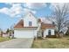 Charming two-story home showcasing a manicured lawn, two-car garage, and a classic architectural design at 1542 Waterford Dr, Zionsville, IN 46077