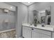 This bathroom features a double sink vanity and large mirror at 16917 Sandhurst Pl, Westfield, IN 46074