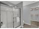 Modern bathroom featuring a glass shower, neutral tones, and convenient shelving for optimal organization at 16917 Sandhurst Pl, Westfield, IN 46074