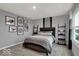 Cozy bedroom features natural light, dinosaur wall decor, and modern ladder shelving for storage and display at 16917 Sandhurst Pl, Westfield, IN 46074