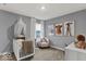 Charming Bedroom with a crib, comfortable chair, and adorable animal artwork for a cozy atmosphere at 16917 Sandhurst Pl, Westfield, IN 46074