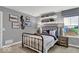 Charming bedroom featuring themed decor, decorative shelving and large window, bathed in natural light at 16917 Sandhurst Pl, Westfield, IN 46074