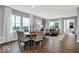 Bright dining area showcasing a modern chandelier, hardwood floors, and neutral color palette at 16917 Sandhurst Pl, Westfield, IN 46074