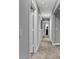 Bright hallway featuring neutral carpeting, fresh grey walls and white doors giving way to other rooms at 16917 Sandhurst Pl, Westfield, IN 46074