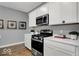 Close up of modern kitchen featuring stainless steel appliances and white cabinetry at 16917 Sandhurst Pl, Westfield, IN 46074