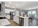 An open kitchen with stainless steel appliances and an adjacent dining area with natural light at 16917 Sandhurst Pl, Westfield, IN 46074