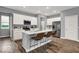 A modern kitchen featuring white cabinetry, stainless steel appliances, and an island with bar seating at 16917 Sandhurst Pl, Westfield, IN 46074