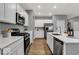 A well-equipped kitchen with stainless steel appliances and white cabinets at 16917 Sandhurst Pl, Westfield, IN 46074