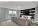 This living room features a gray sofa, built-in shelving and a view at 16917 Sandhurst Pl, Westfield, IN 46074