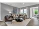 Comfortable living room featuring plush seating, modern accents, and hardwood floors at 16917 Sandhurst Pl, Westfield, IN 46074
