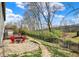 Spacious backyard with pea gravel and lush green grass, a fire pit area, and a metal fence at 17420 Dalton Ct, Noblesville, IN 46062