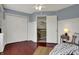 Comfortable bedroom featuring a closet, doorway to another room, and large window at 17420 Dalton Ct, Noblesville, IN 46062