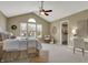 Bright bedroom with vaulted ceiling, large window, writing desk, and comfortable seating area with natural light at 17420 Dalton Ct, Noblesville, IN 46062